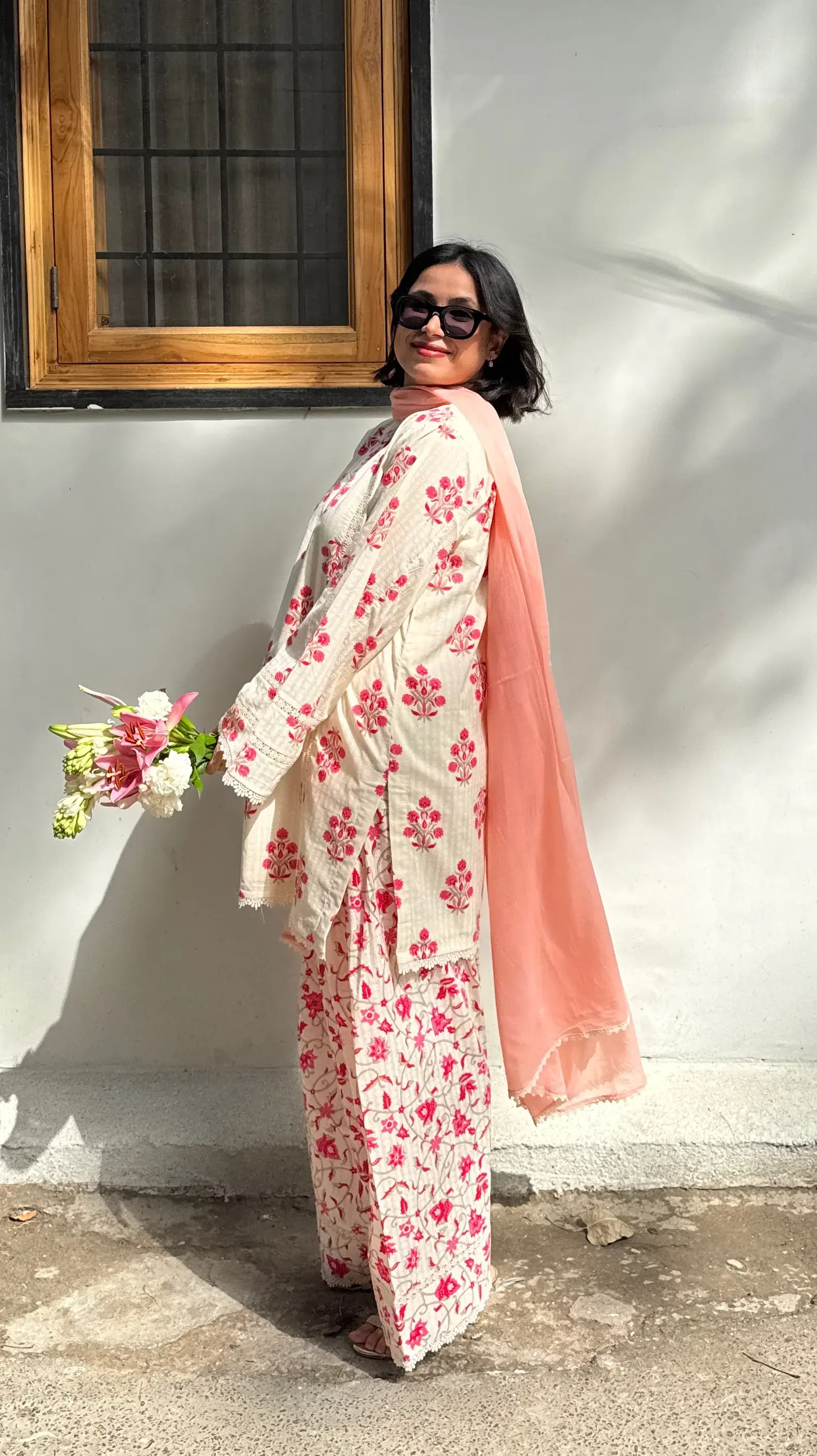 Breathable block print suit set in pinkish red with floral booties and lace-detailed dupatta