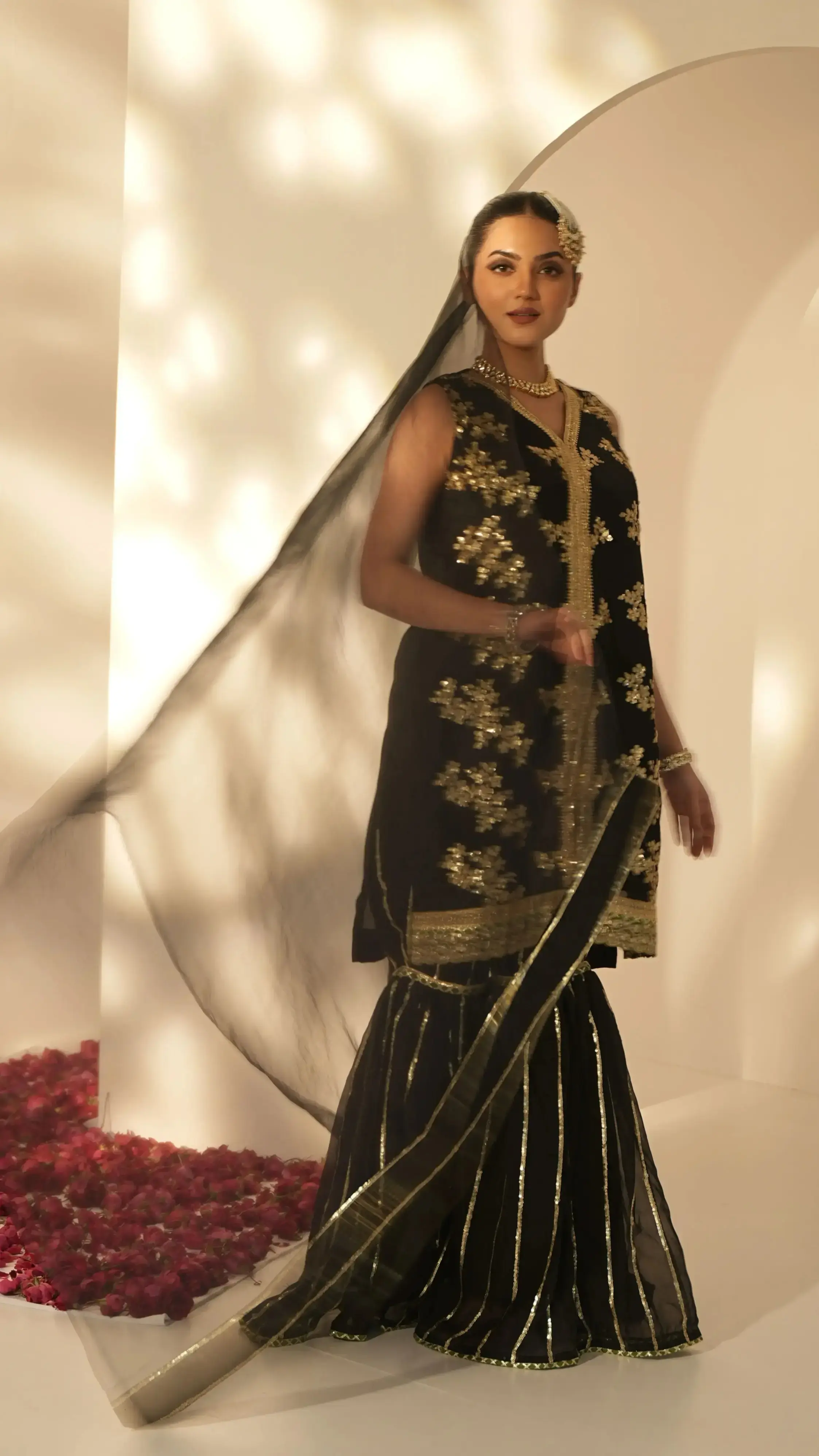 Black festive suit with sharara and green-golden lace, crafted for weddings and festive evenings