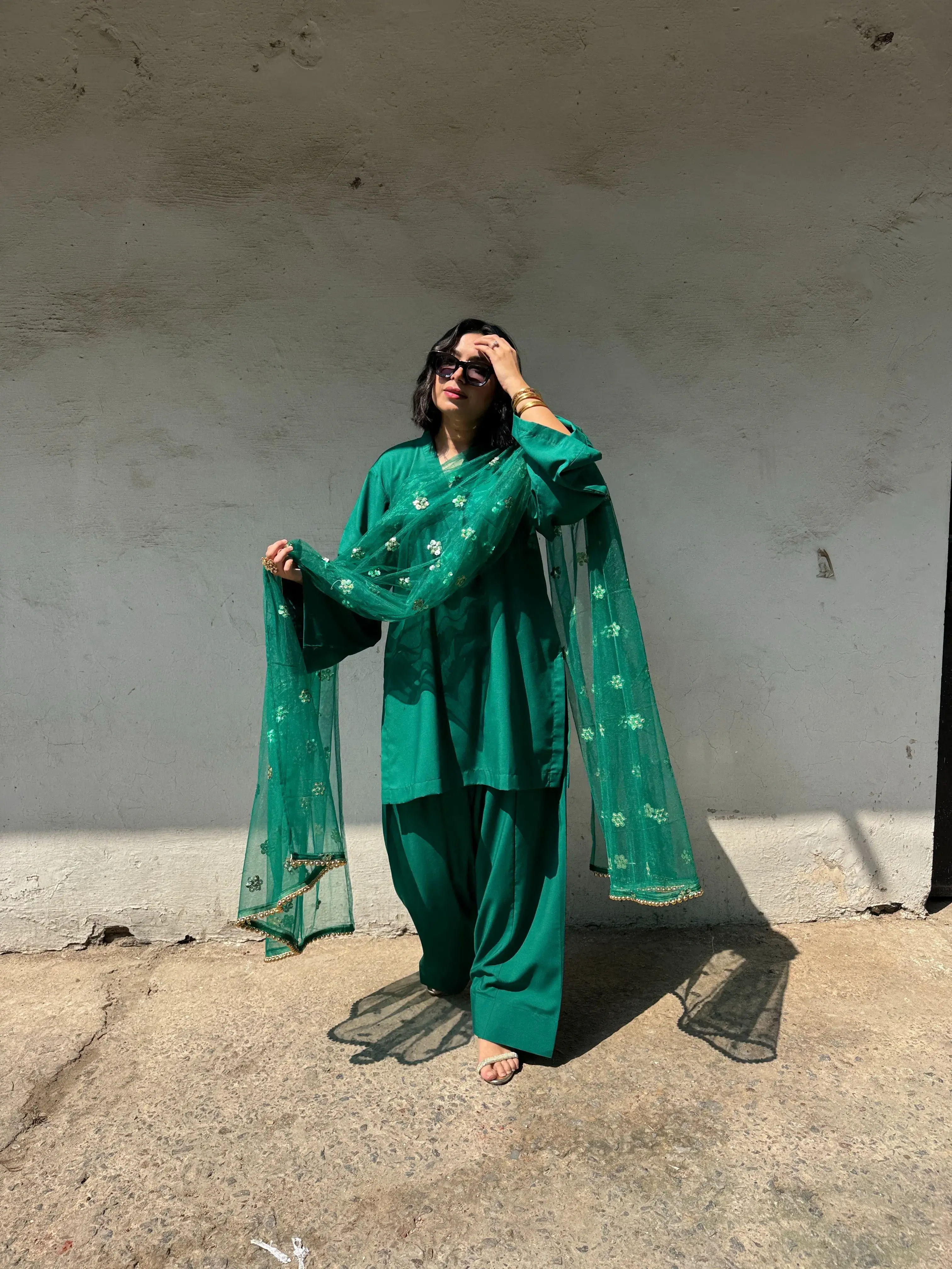 Traditional emerald green suit women with farshi salwar and net dupatta for festive Teej wear